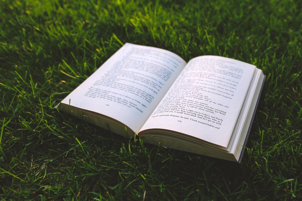 Free Image of Open Book on Lush Green Field 