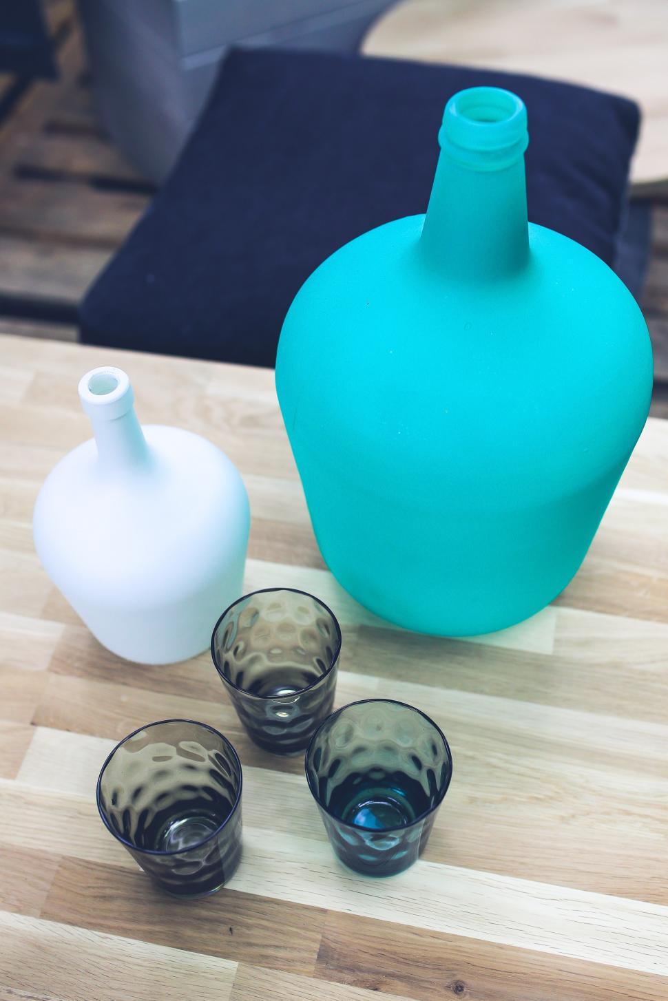 Free Image of Glasses and Blue Vase on Table 