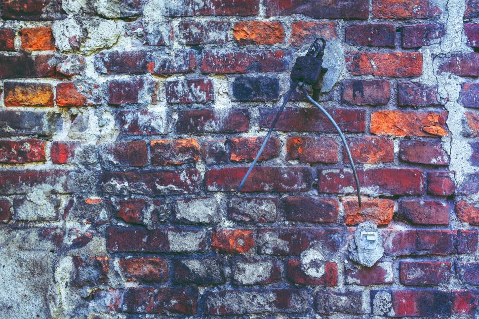 Free Image of Red Brick Wall With Wire Attachment 