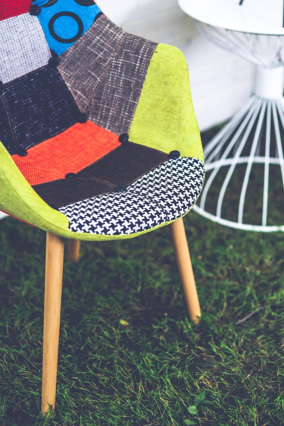 Free Image of Colorful Chair on Lush Green Field 