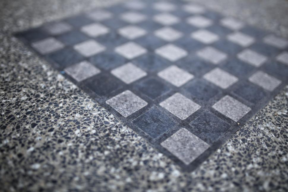 Free Image of Black and White Checkerboard Pattern on Ground 