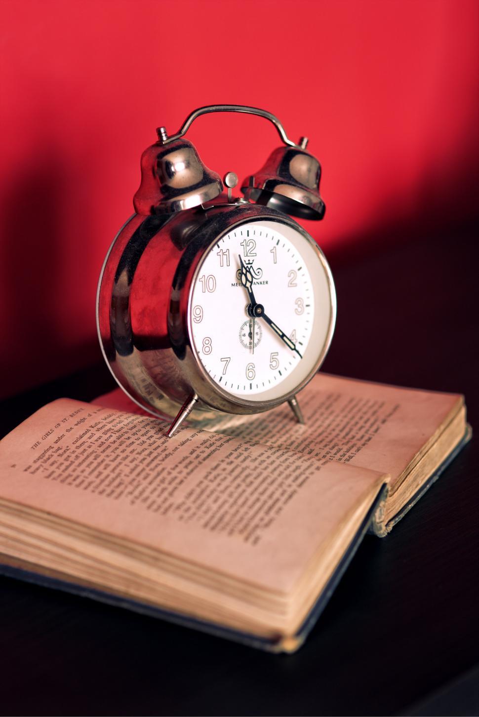 Free Image of Alarm Clock on Open Book 