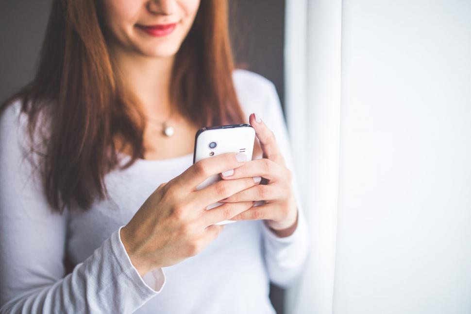 Free Image of Woman Looking at Her Cell Phone 