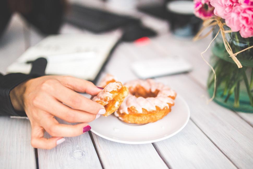 Free Image of Person Holding a Donut on a White Plate 