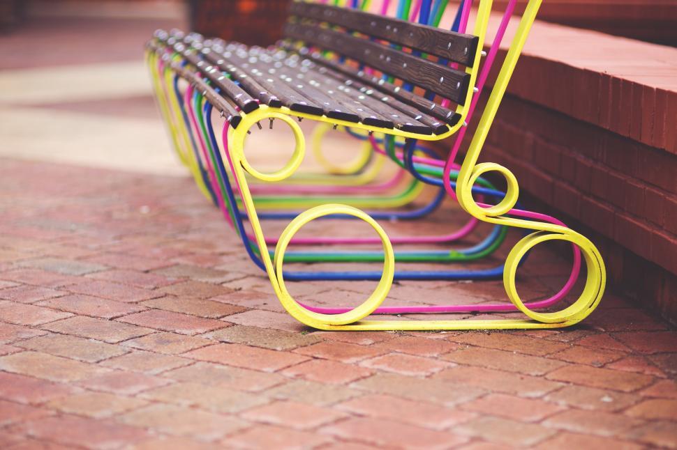 Free Image of Colorful Benches on Brick Floor 