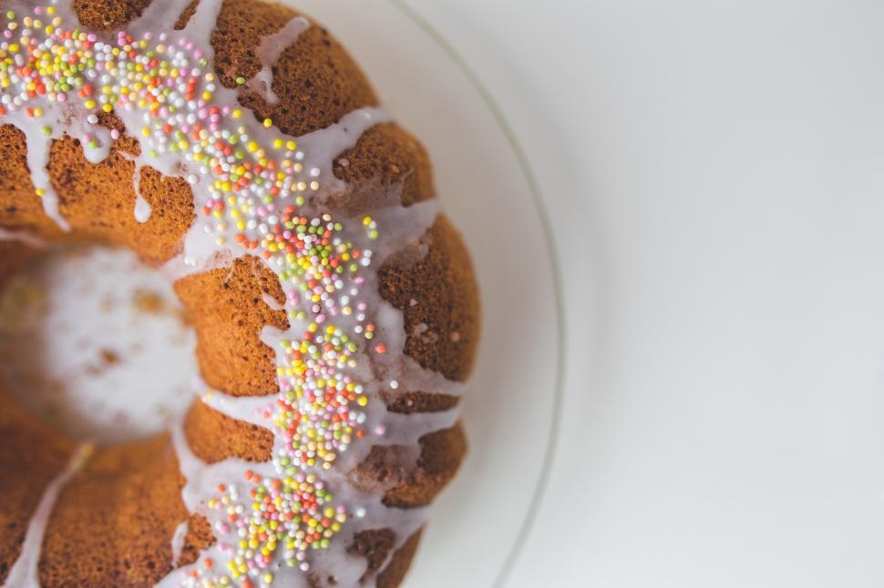 Free Image of Delicious Bundt Cake With White Icing and Sprinkles 