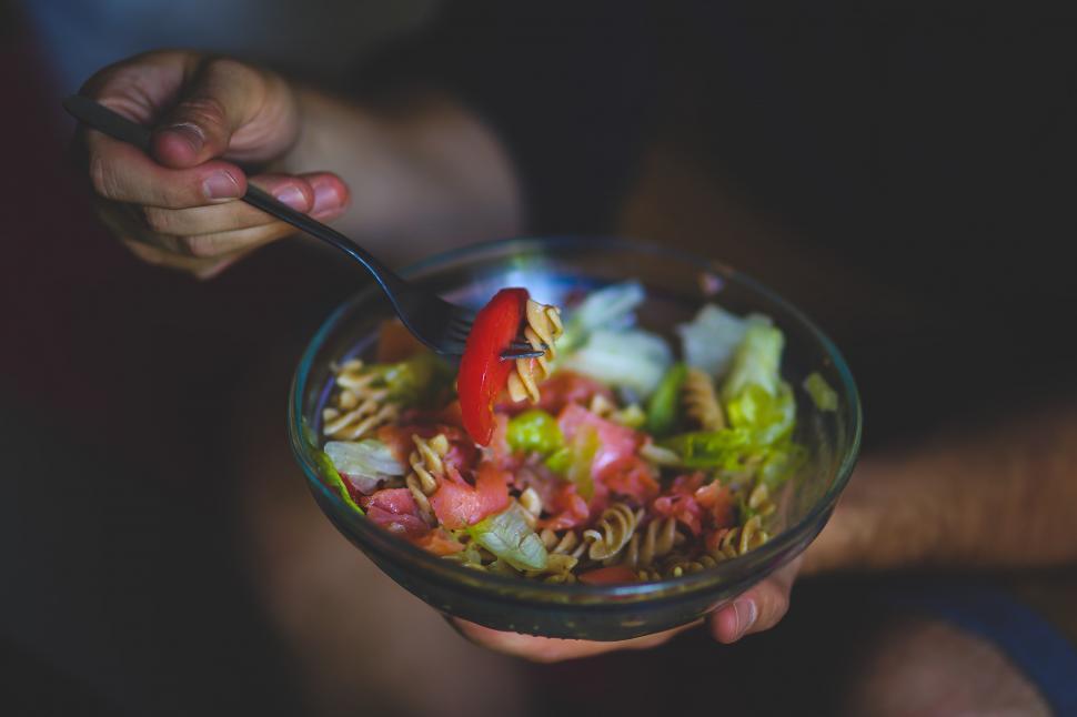 Free Image of Person Holding Bowl of Food With Spoon 