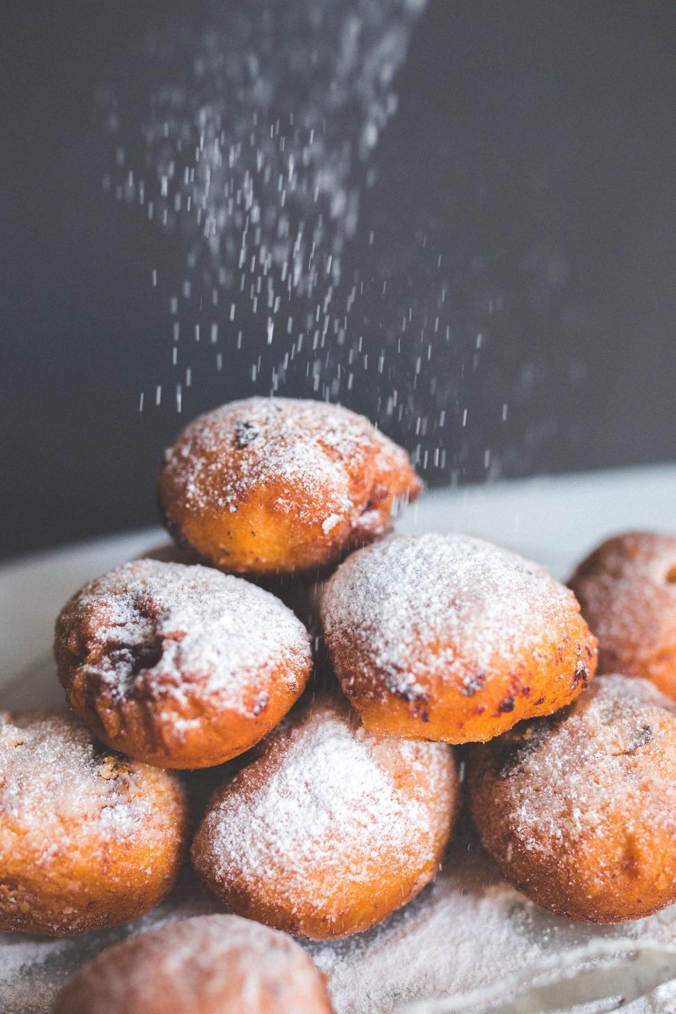 Free Image of Pile of Powdered Sugar Donuts on White Plate 