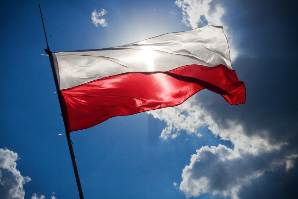 Free Image of Red and White Flag Flying in the Sky 