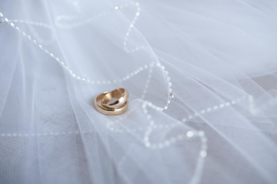Free Image of Gold Wedding Ring on White Veil 