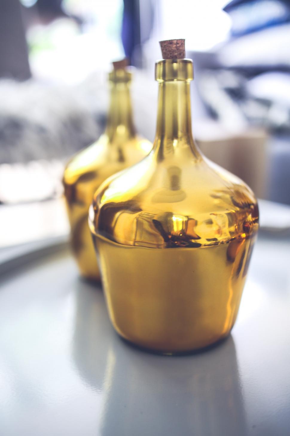 Free Image of Close Up of a Gold Colored Bottle on a Table 