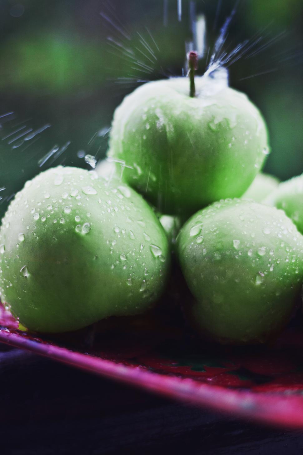 Free Image of Group of Green Apples on Red Cloth 