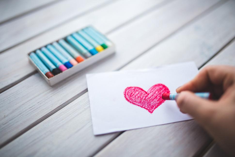 Free Image of Person Drawing a Heart on Paper 
