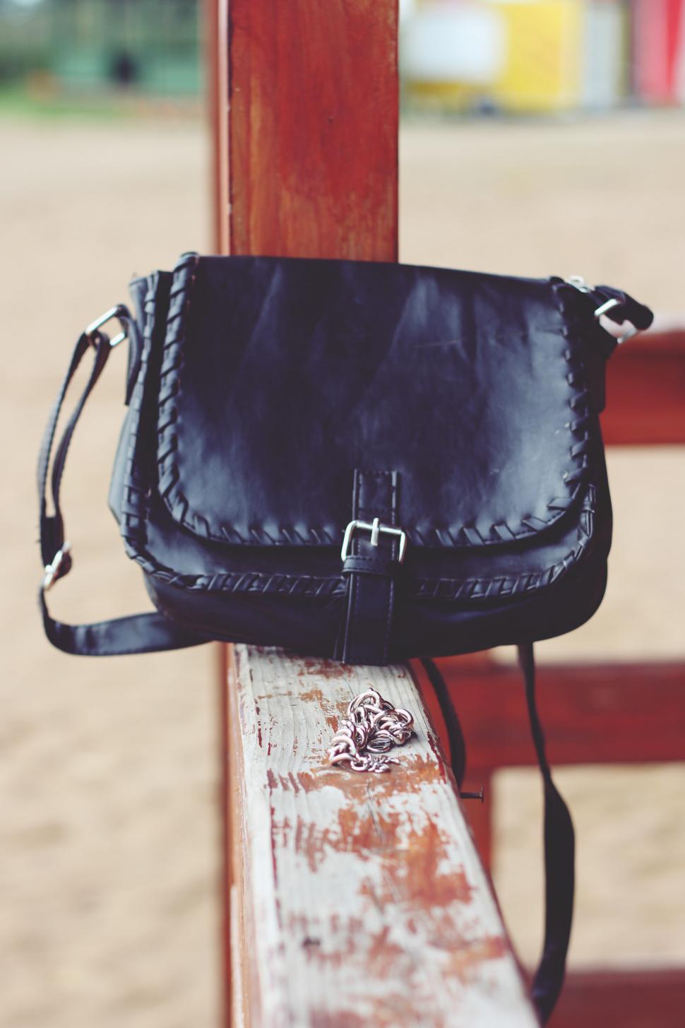 Free Image of Black Purse on Wooden Bench 
