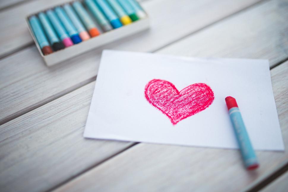 Free Image of Heart Drawing Next to Crayons 