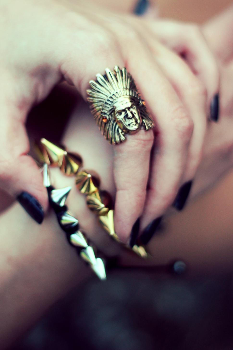 Free Image of Womans Hands With Gold and Black Nail Polish 