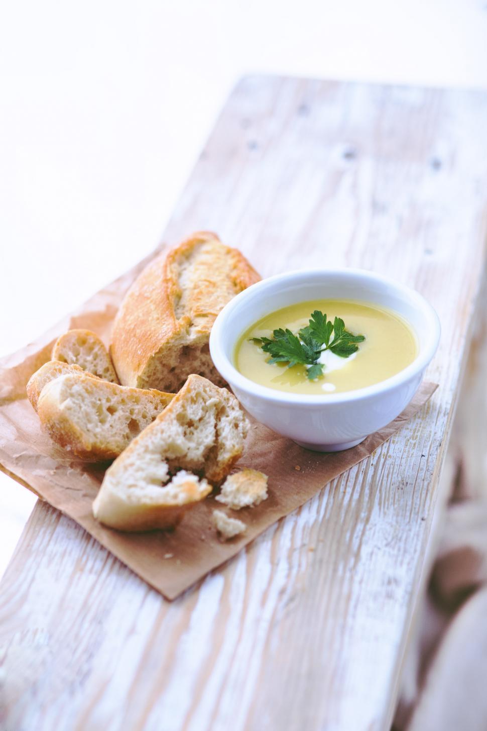 Free Image of A Bowl of Soup and Some Bread on a Table 