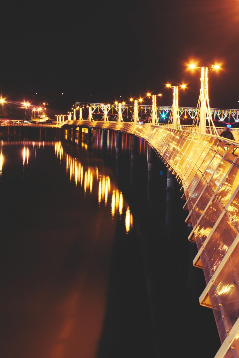 Free Image of A Bridge Over a Body of Water at Night 