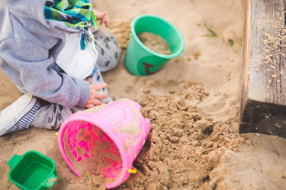 Free Image of Child Playing in Sand With Toys 