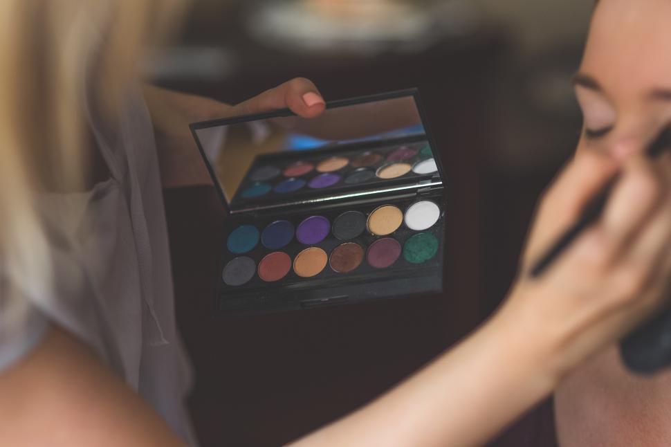 Free Image of Woman Holding Makeup Palette 