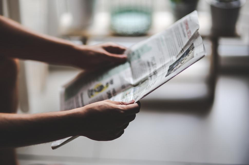 Free Image of Person Reading Newspaper on Table 