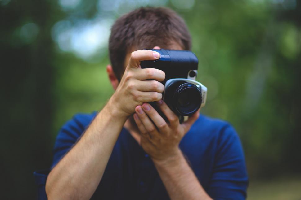 Free Image of Camera Holding Image Picture Taking boy canon guy hobby lense man passion people photo photographer photography technology person people man caucasian adult male photographer portrait binoculars boy face attractive youth 