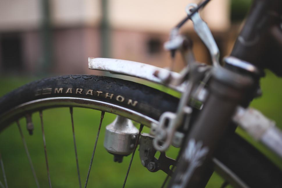 Free Image of Close Up of a Bike With Building in Background 