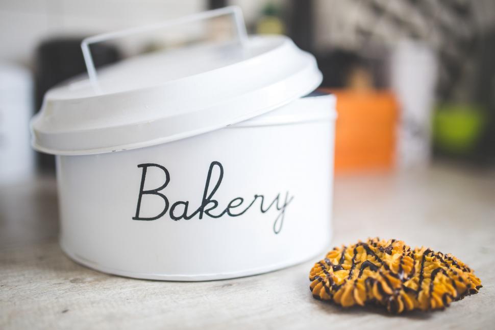 Free Image of Cookie Beside White Container on Counter 
