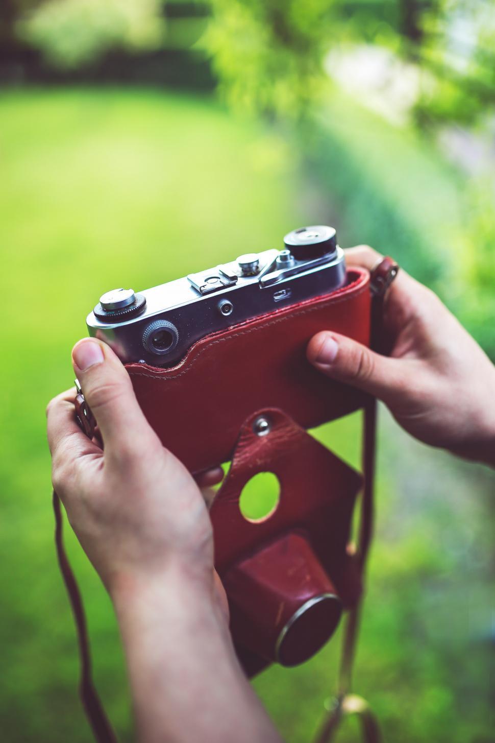 Free Image of Person Holding Red Camera 