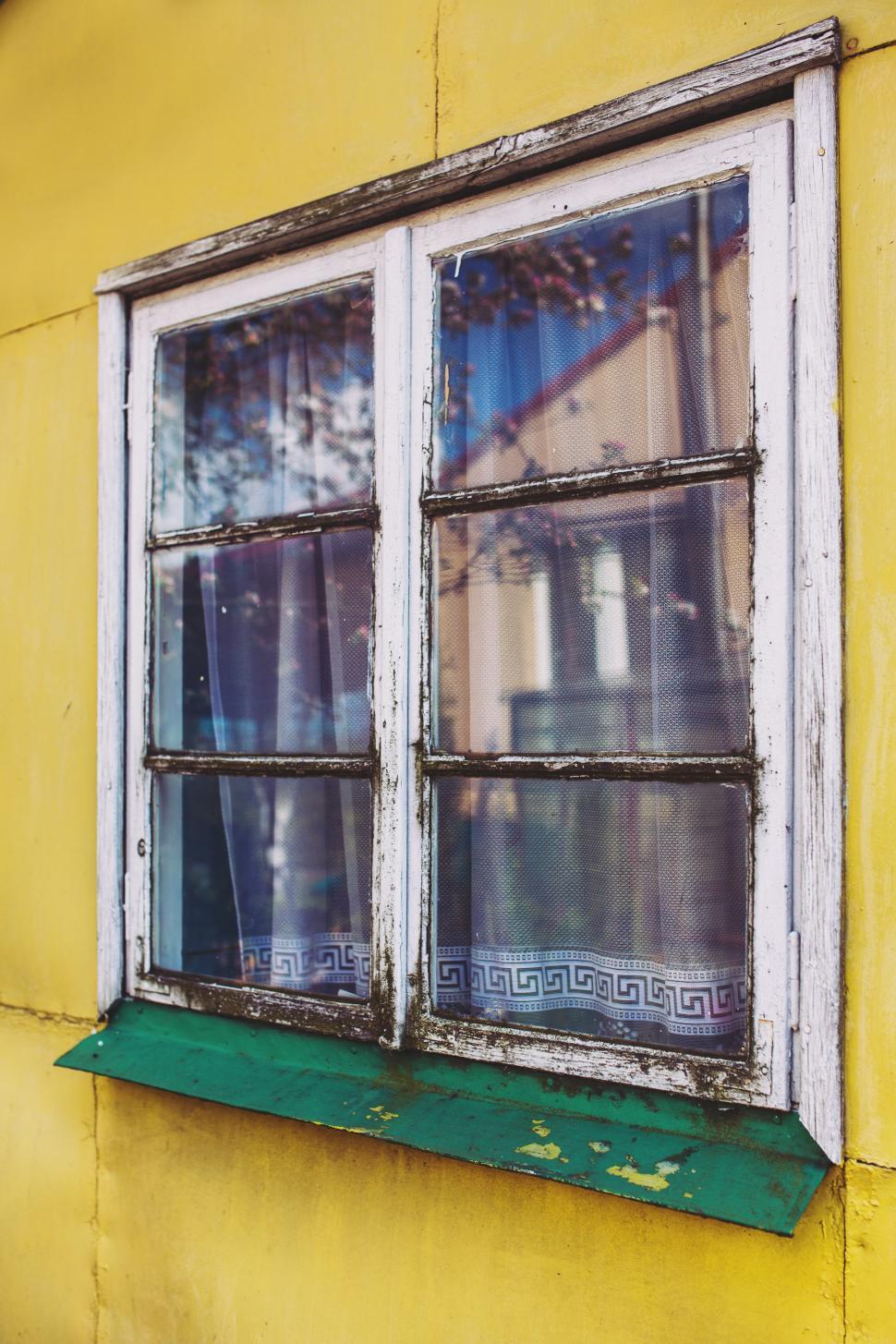 Free Image of Yellow Building With Window and Curtain 