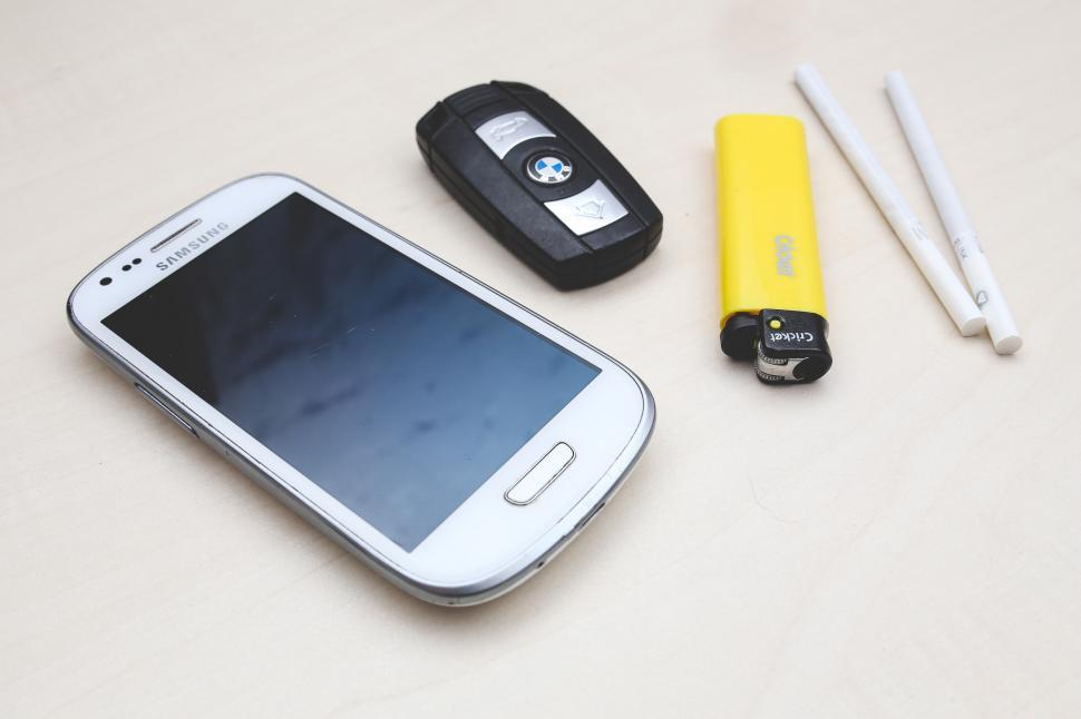 Free Image of Cell Phone, Battery, and Pen on Table 