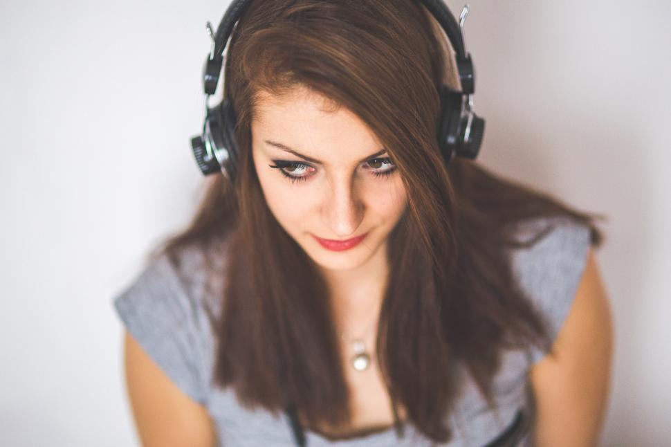 Free Image of Woman Wearing Headphones and Looking at Camera 