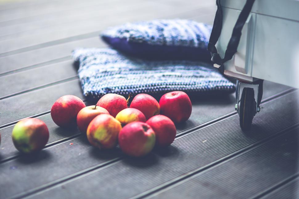 Free Image of A Pile of Apples on a Wooden Table 
