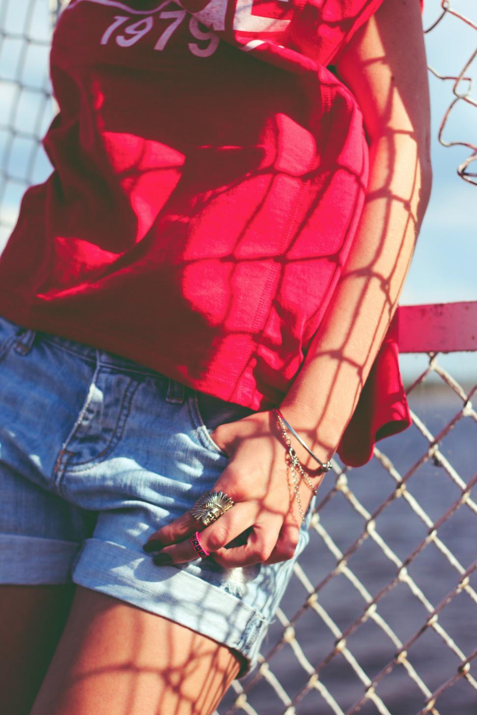 Free Image of Fence Red Ring blouse bracelet chain link jeans jewellery jewelry shorts person man happy 