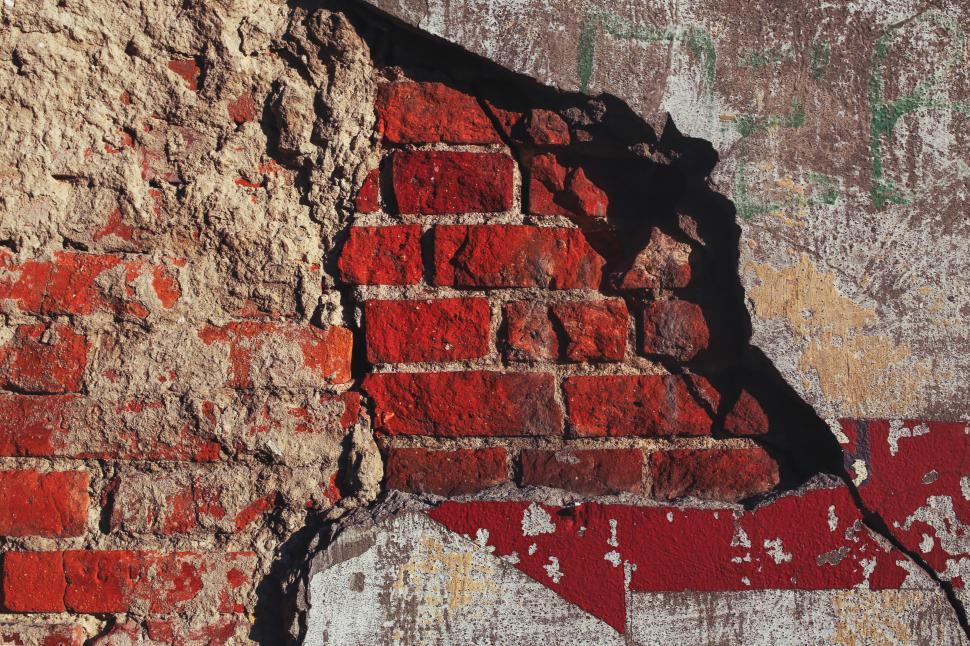 Free Image of Red Arrow Painted on Brick Wall 