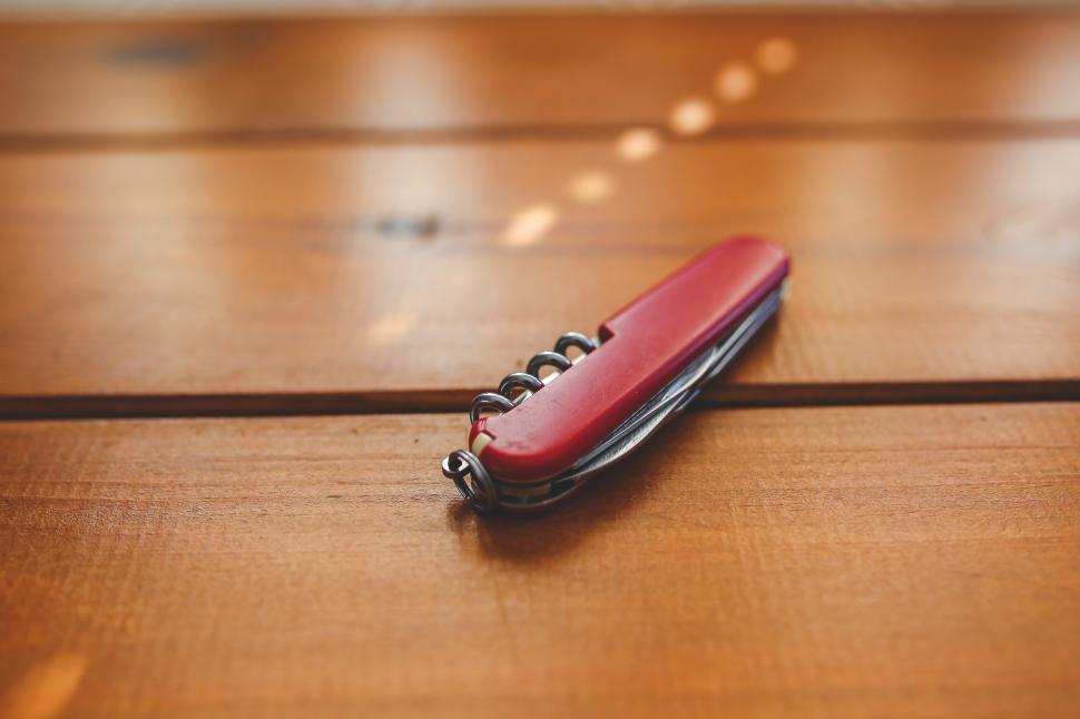 Free Image of Red and Black Cell Phone on Wooden Table 