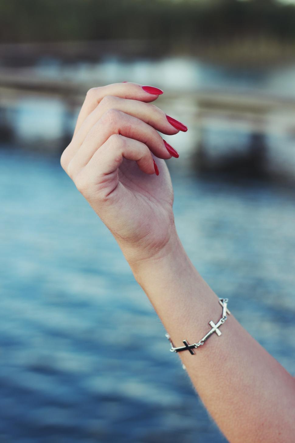 Free Image of Womans Arm Adorned With Cross Bracelet 