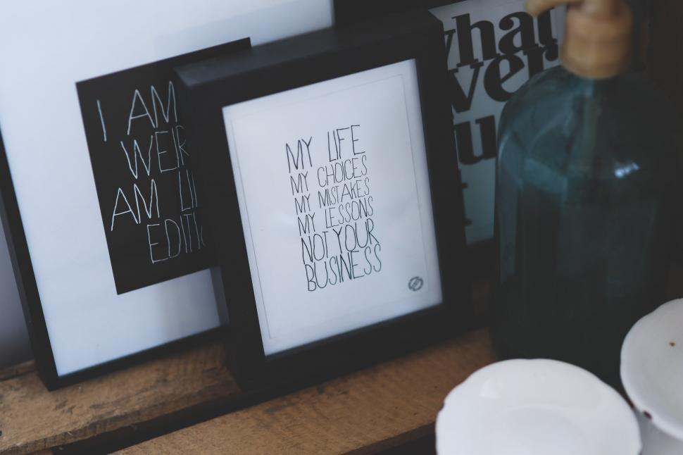 Free Image of Framed Pictures on Wooden Table 