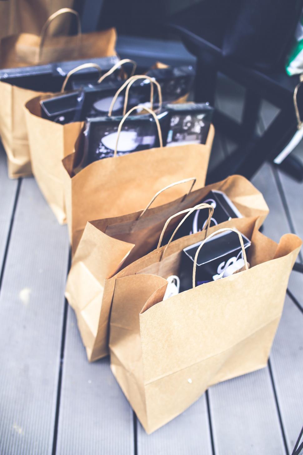 Free Image of Group of Brown Bags on Wooden Floor 