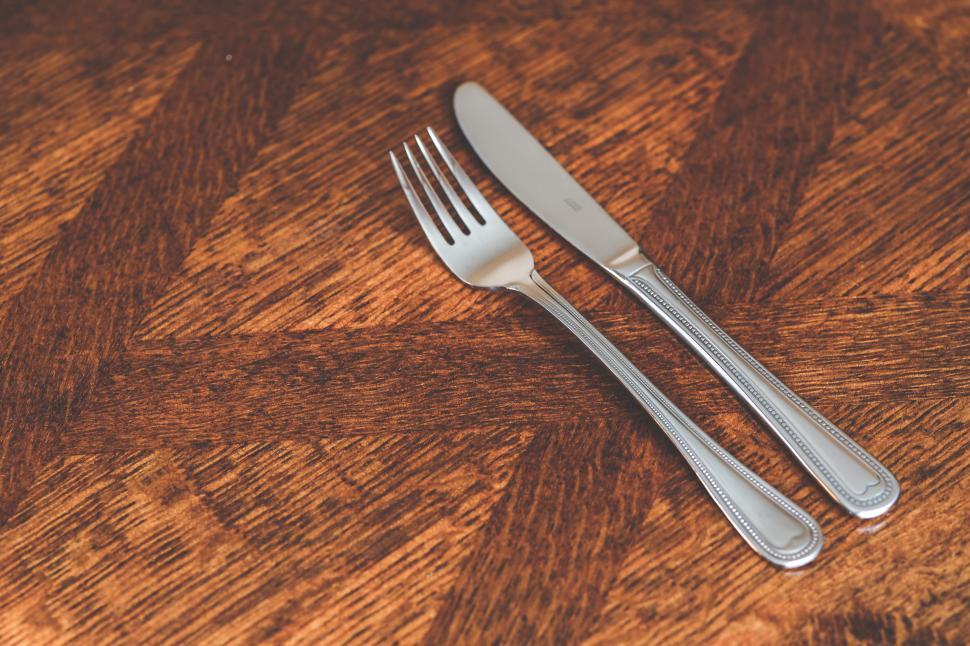 Free Image of Close Up of a Fork and a Knife on a Table 