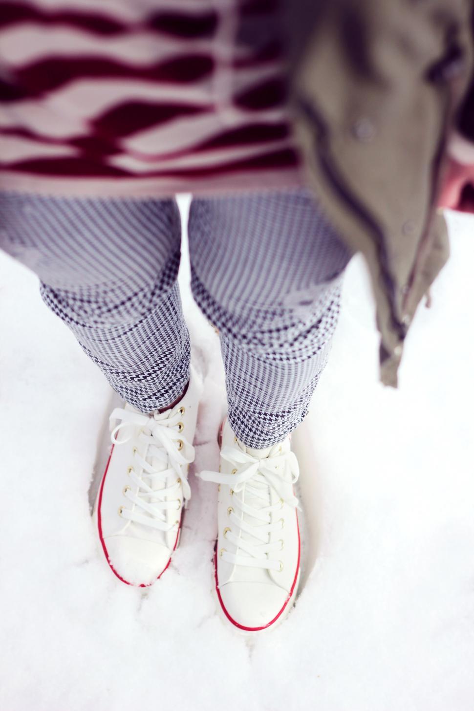 Free Image of Person Standing in Snow With White Tennis Shoes 