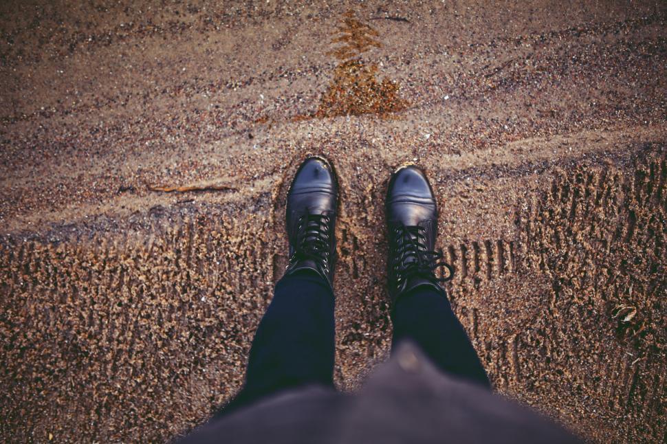 Free Image of Person Standing on Sidewalk in Black Shoes 