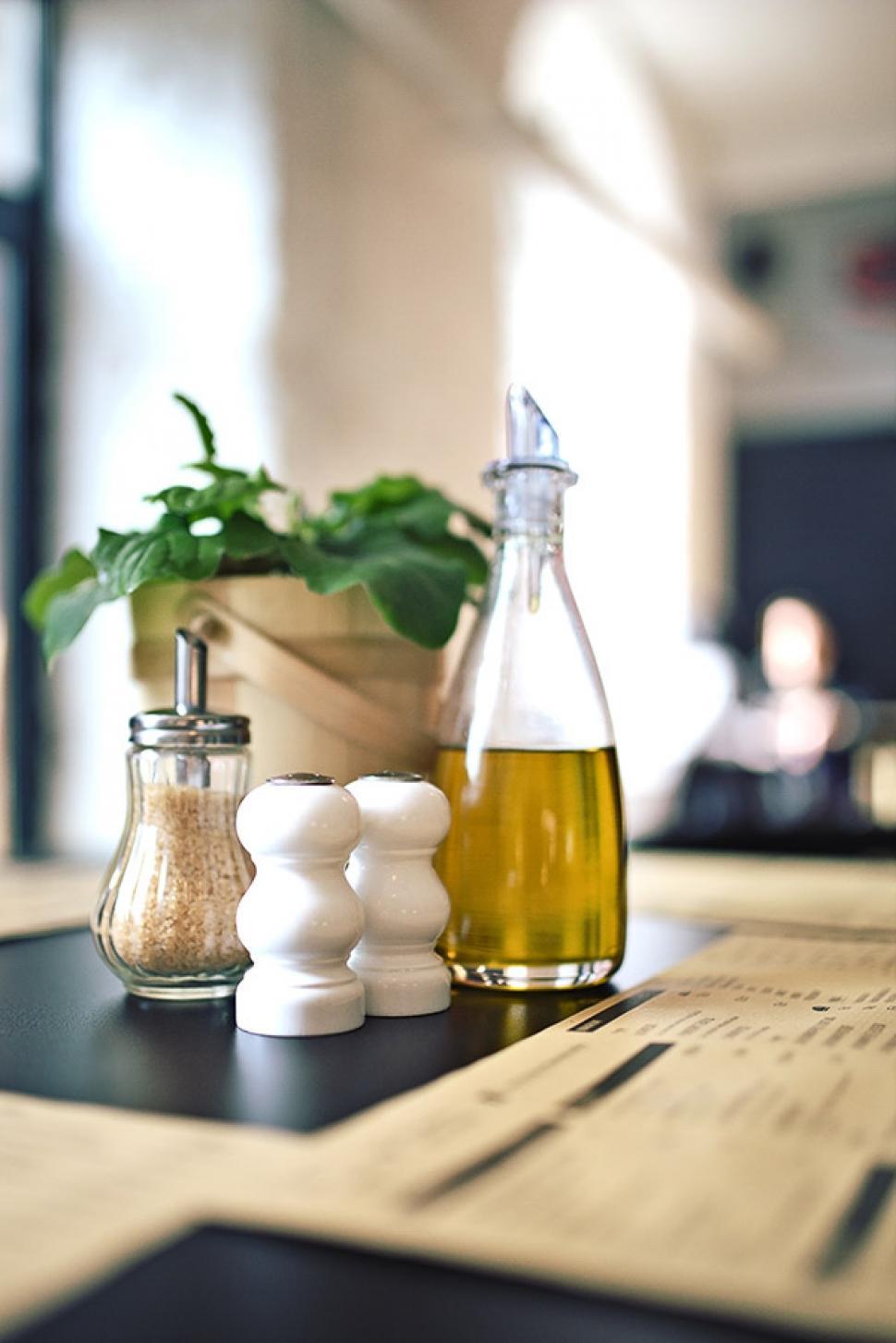 Free Image of Table With Olive Oil Bottle and Potted Plant 