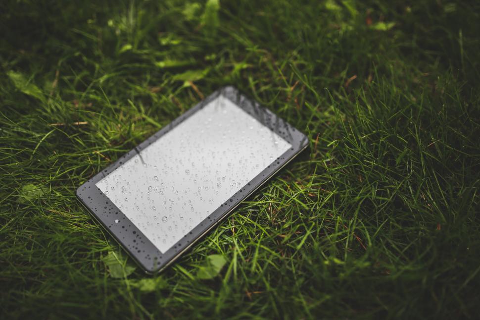 Free Image of Cell Phone on Lush Green Field 
