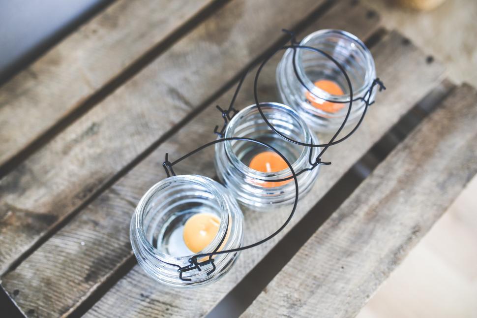 Free Image of Three Glass Candles on Wooden Table 