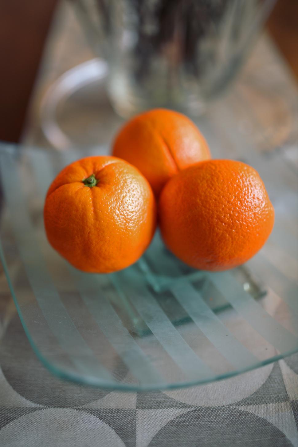 Free Image of Two Oranges on Glass Plate 
