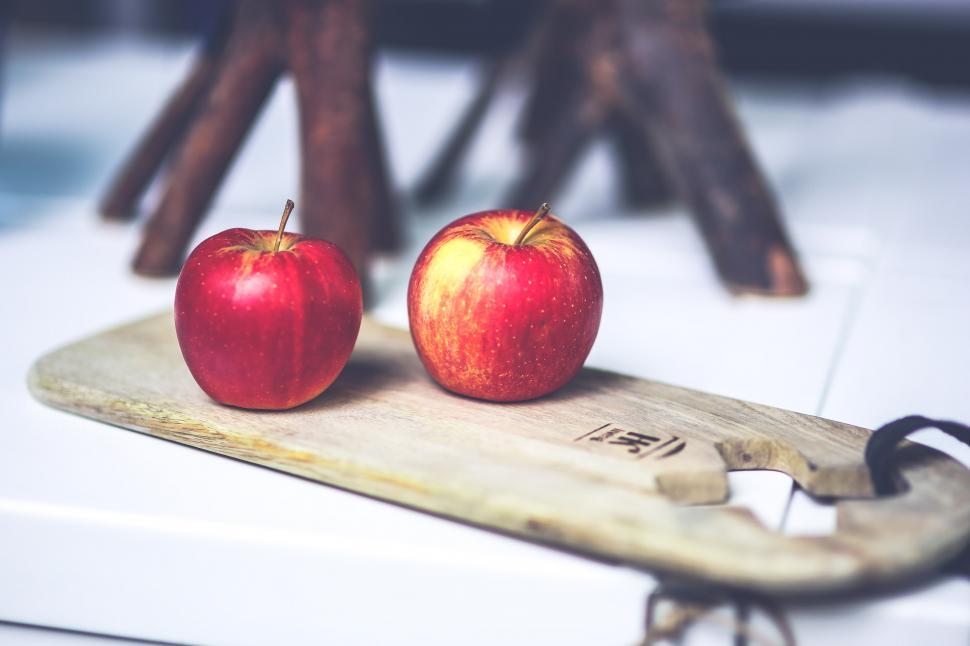Free Image of Two Red Apples on Wooden Skateboard 