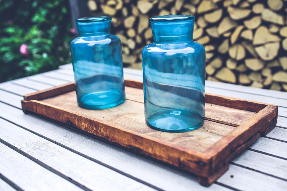 Free Image of Two Blue Glass Vases on Wooden Tray 