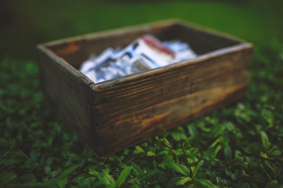Free Image of Wooden Box Filled With Silver Foil on Green Field 