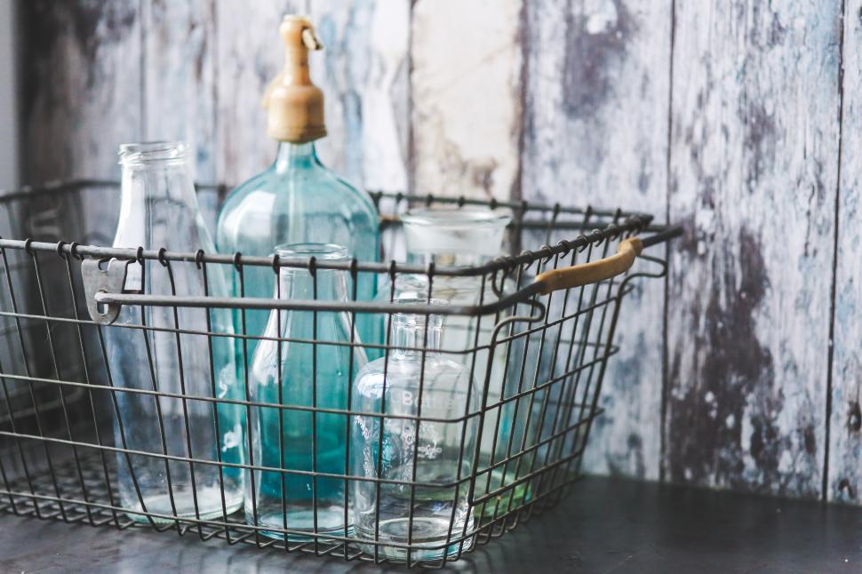 Free Image of Metal Basket With Bottles on Table 